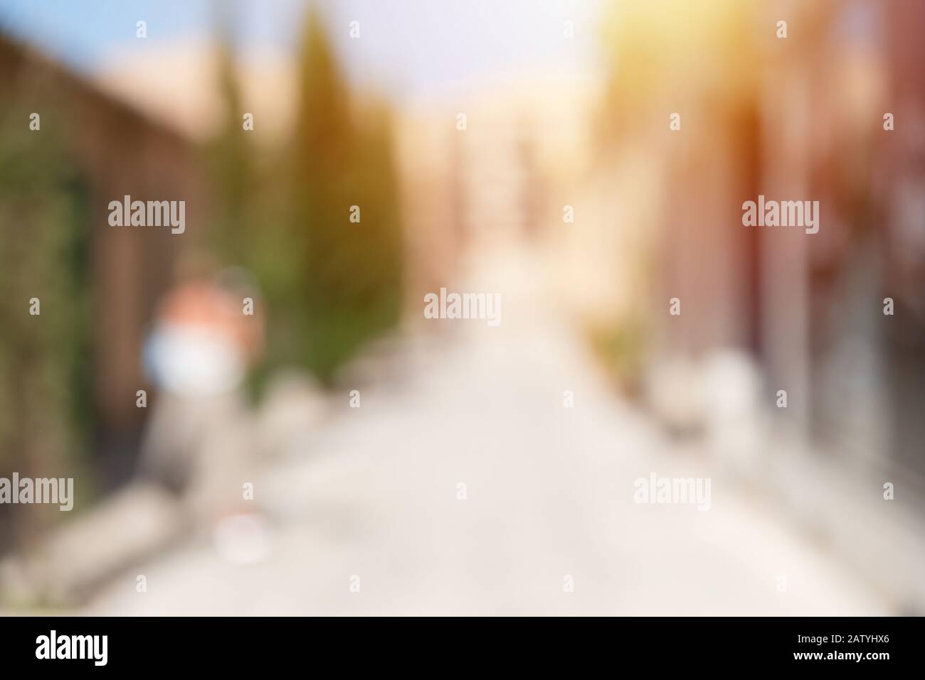 Defocused abstract background of urban city in sunny day, vertical. Deserted street. Stock Photo