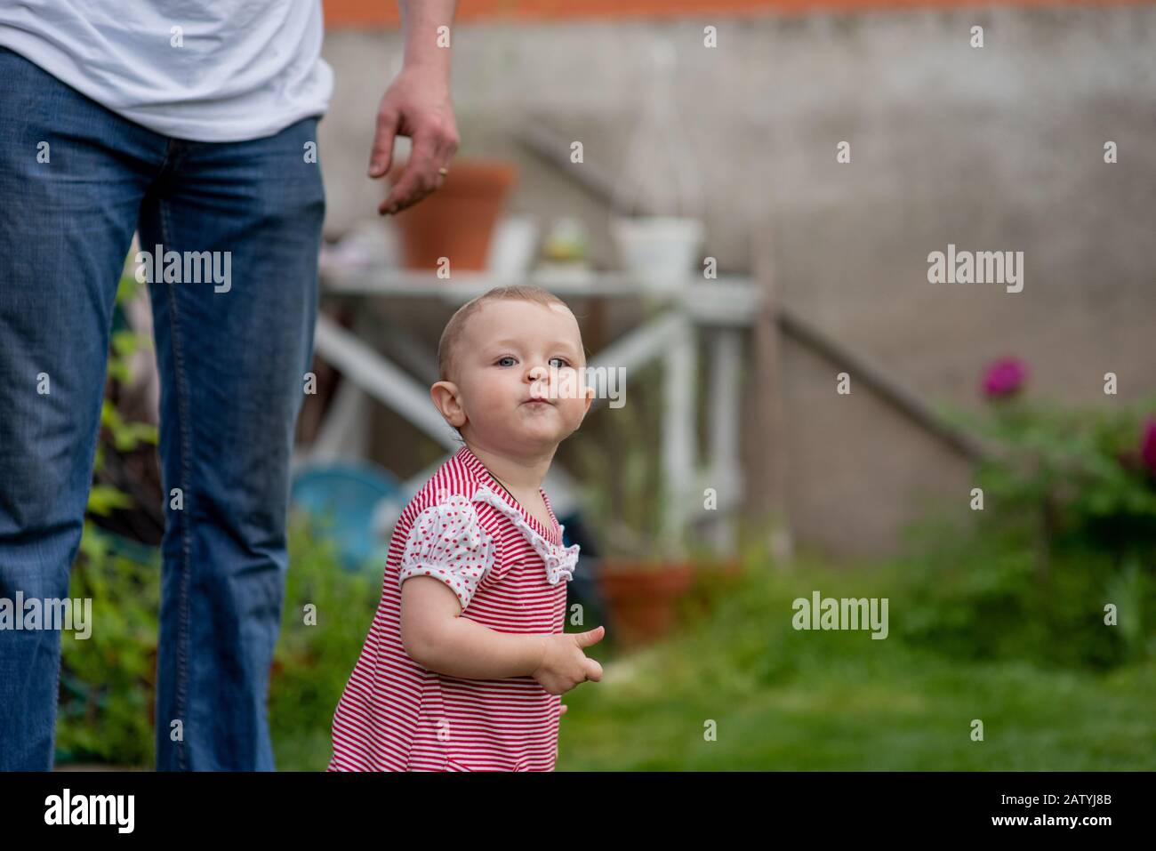 Baby with fathers long legs Stock Photo - Alamy