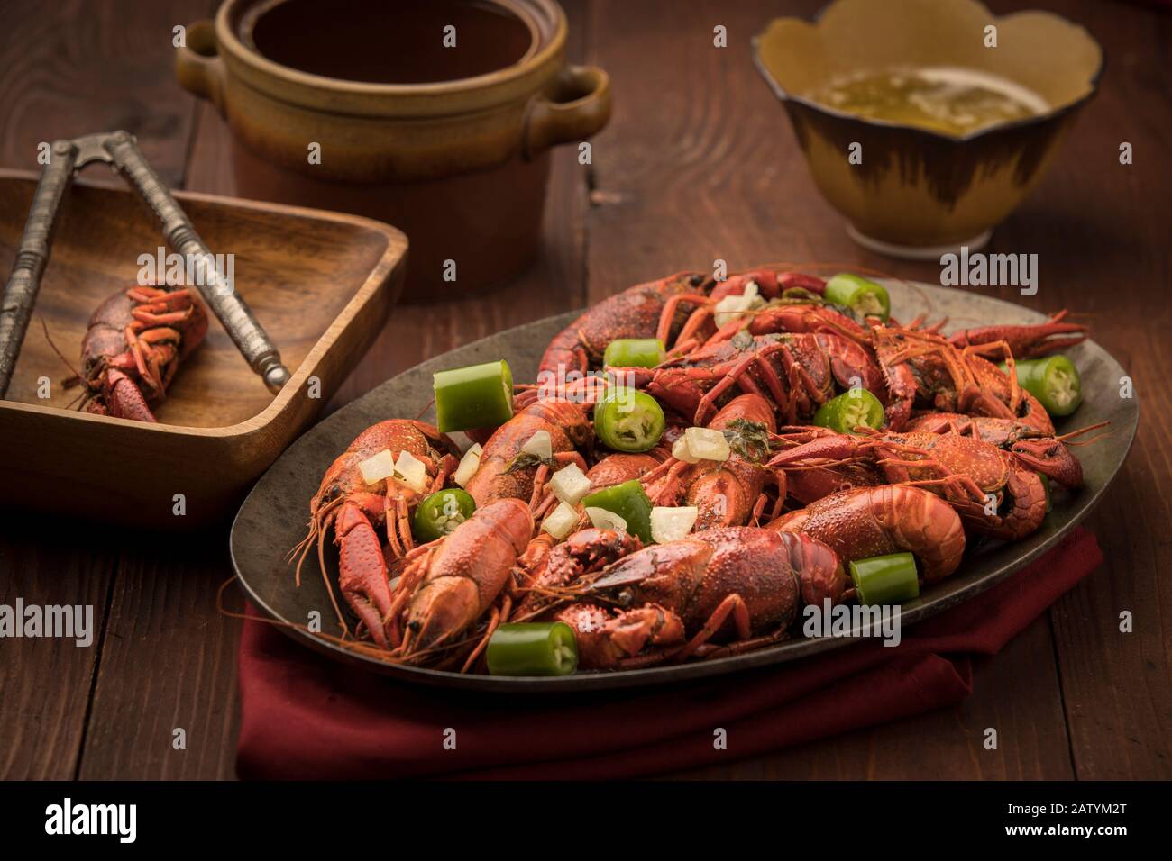 A close up of a platter of steamed crawfish and bits of peppers. Stock Photo