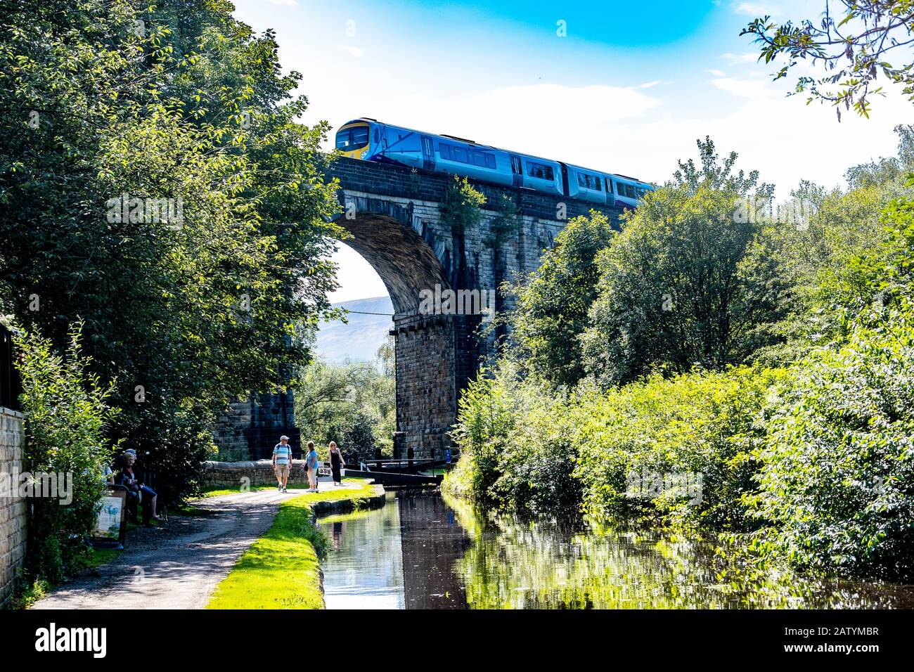 Train passing over viaduct in Saddleworth North of England Stock Photo