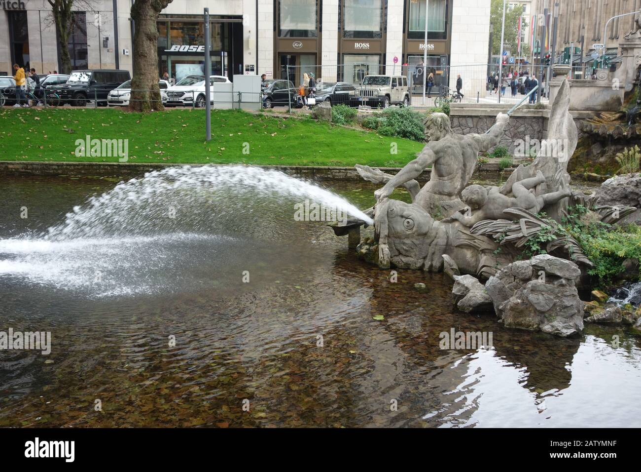 The Tritonenbrunnen or Triton Fountain, an ornately carved fountain on the Koenigsallee canal. Stock Photo