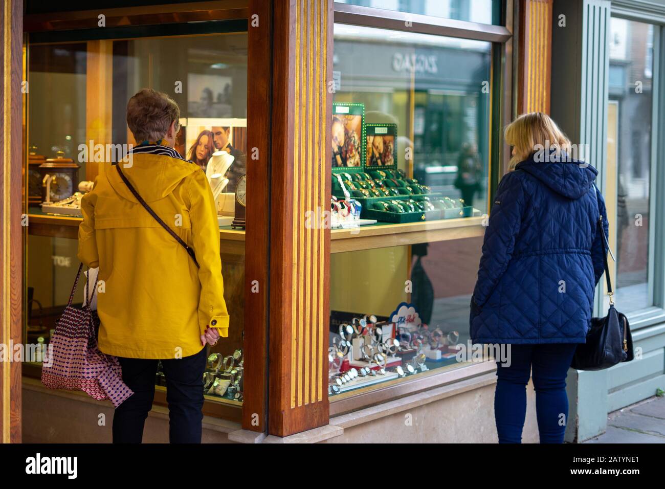 Two middle aged women looking into a jewelry shop window Stock Photo