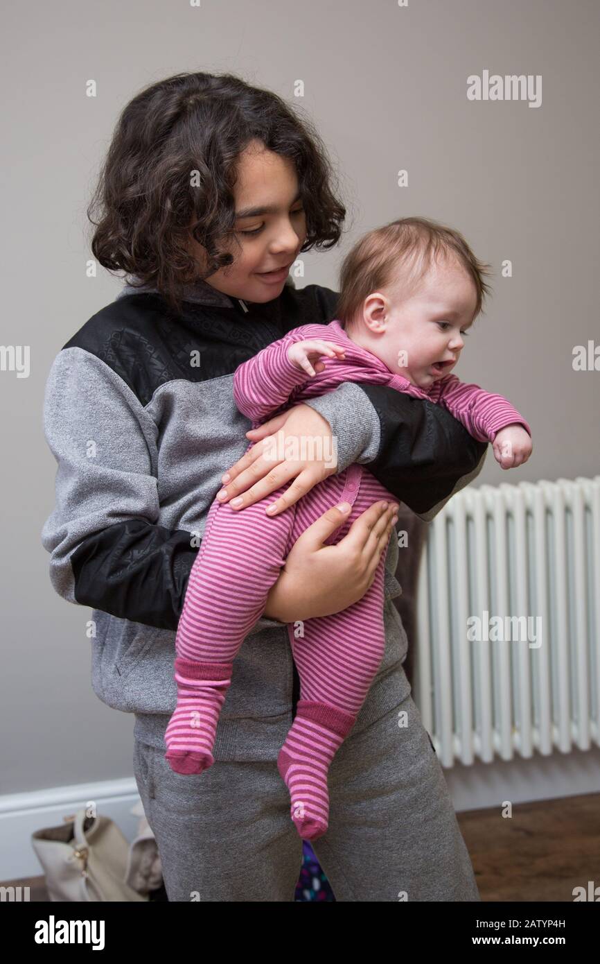 Teenage boy babysitting, UK Stock Photo