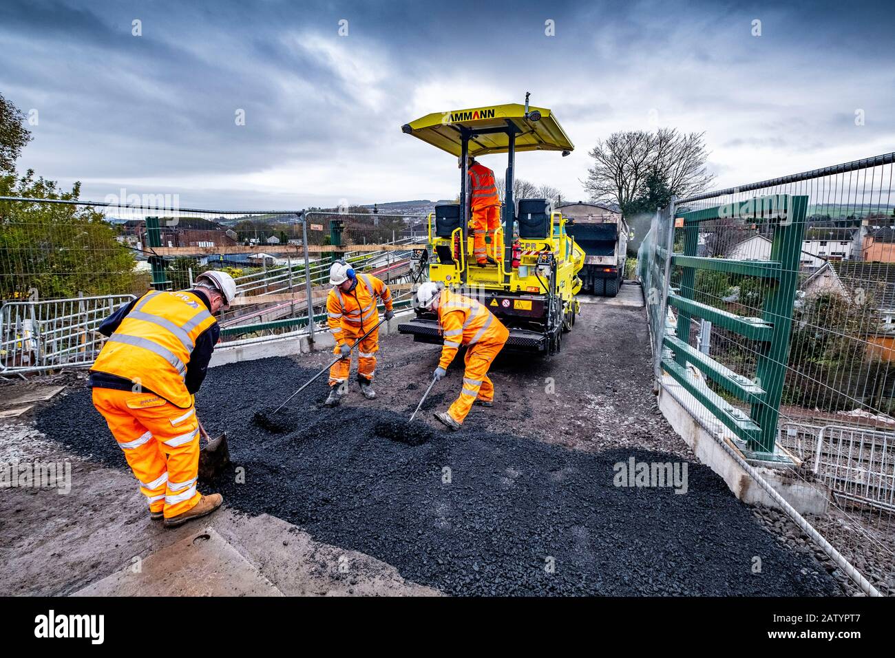 Laying a new road over a rail bridge Stock Photo