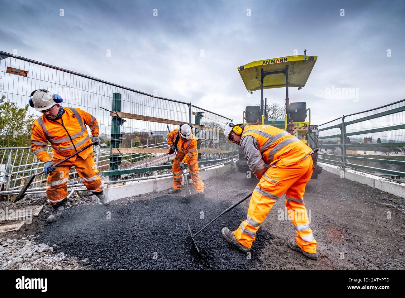 Laying a new road over a rail bridge Stock Photo