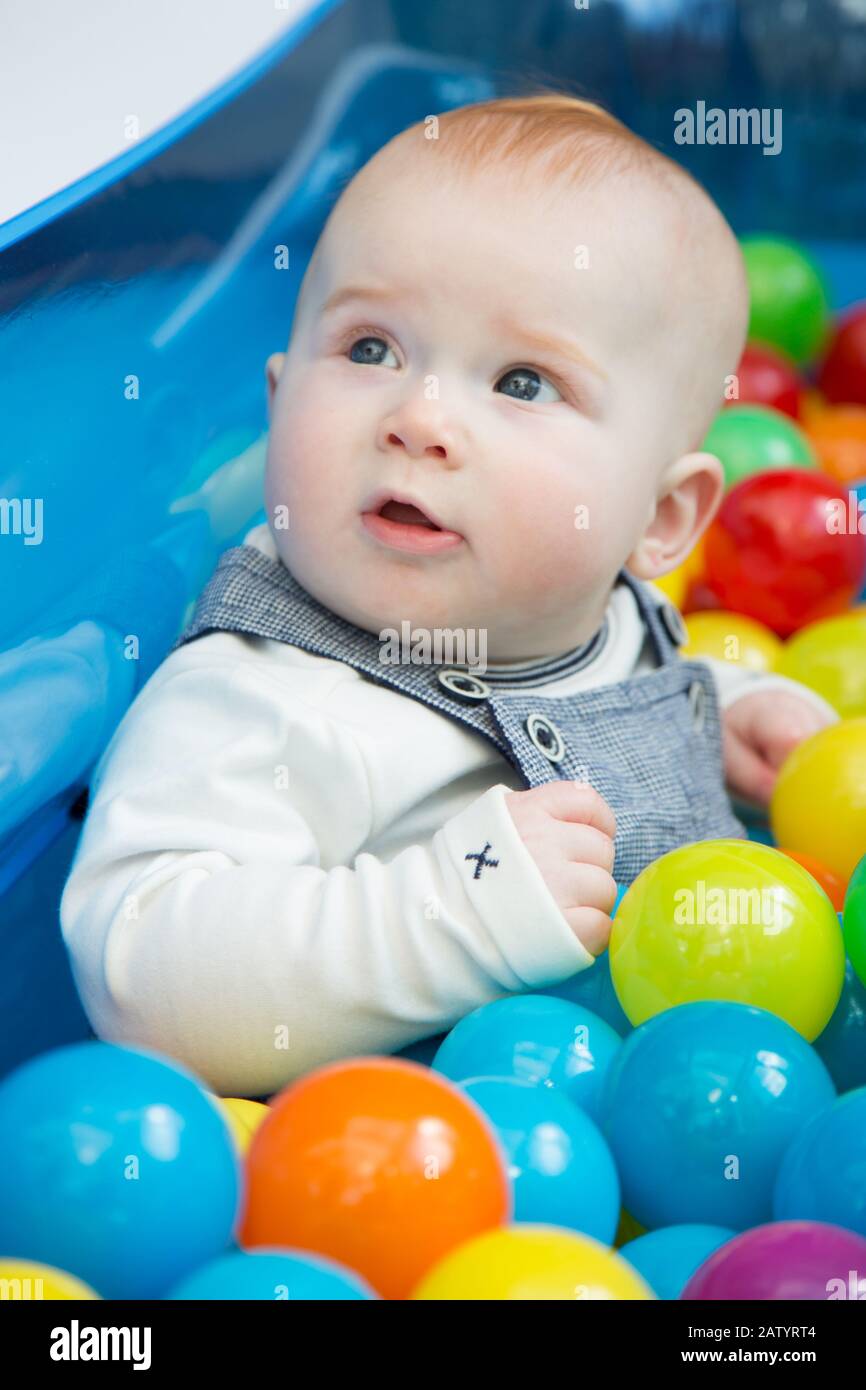 8 month old baby playing in a ball pit, UK Stock Photo Alamy