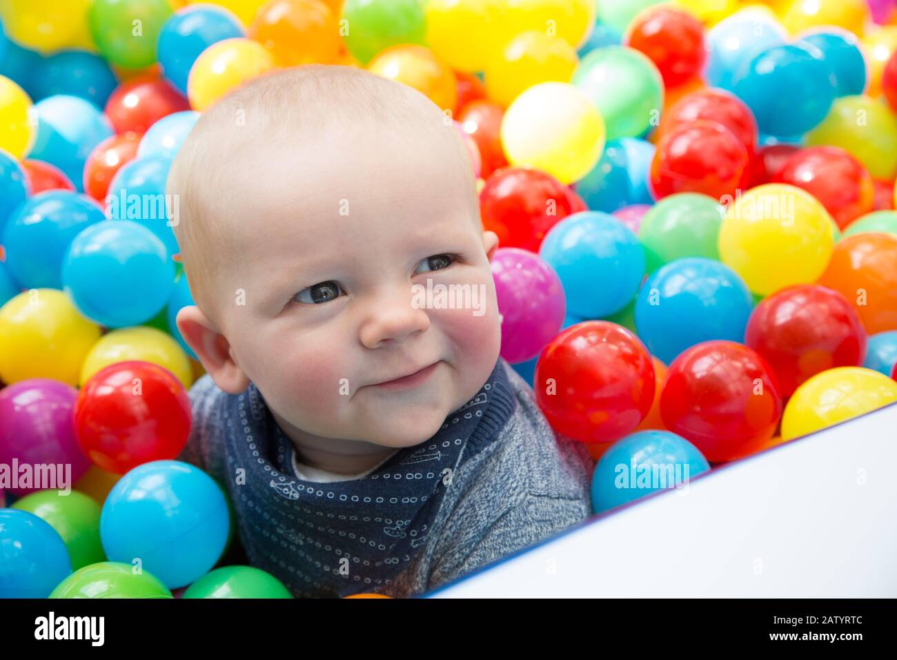 8 month old baby playing in a ball pit, UK Stock Photo Alamy