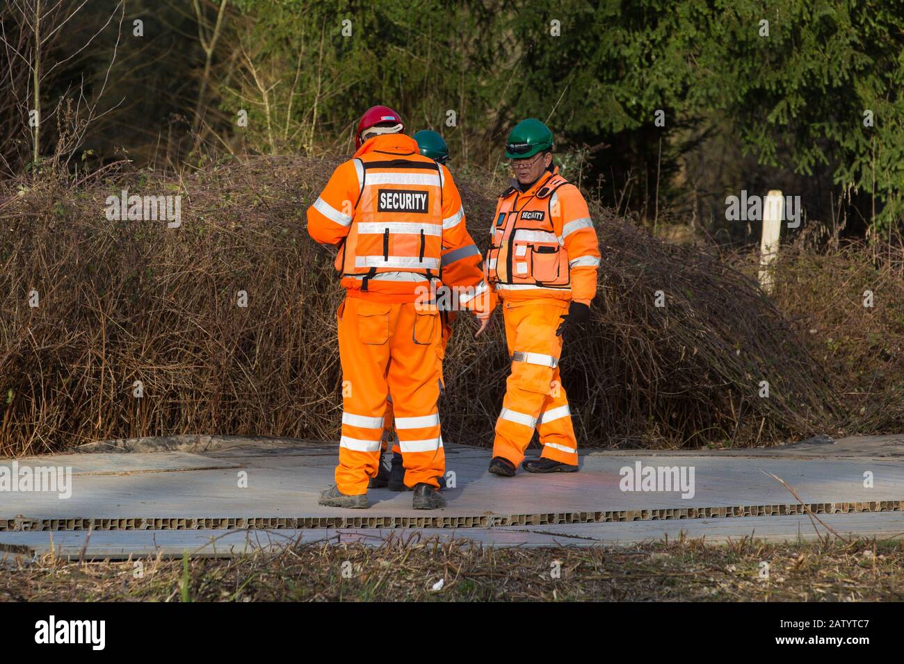 Denham, UK. 5 February, 2020. Security guards monitor a temporary roadway laid across land cleared in the Colne Valley for works planned in conjunction with the HS2 high-speed rail link including the felling of ancient trees and the construction of a Bailey bridge across the river Colne and a compound in Denham Country Park. Environmental activists are occupying trees in an attempt to prevent or hinder the work. Credit: Mark Kerrison/Alamy Live News Stock Photo