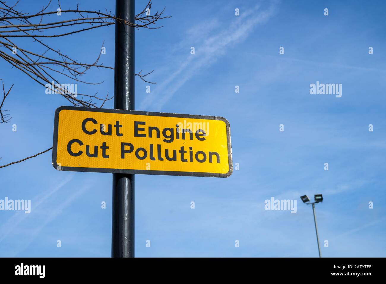 A sign on a lamppost reading cut engine cut pollution Stock Photo