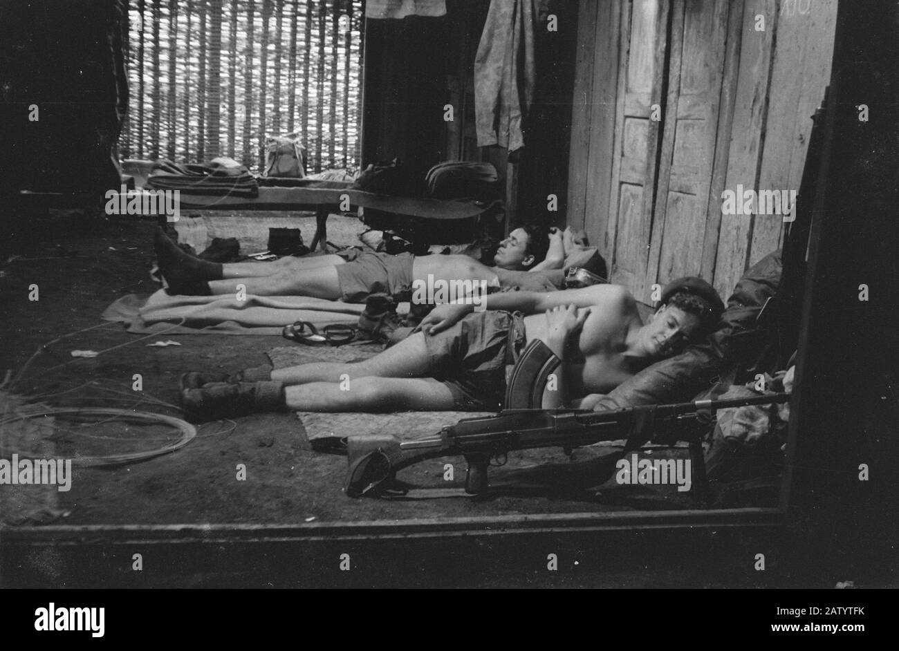 Tengaran complex (in the article 'From Never land protected area' in the journal Wapenbroeders)  Soldiers sleep in a small traditional house. In the foreground a Bren gun Date: November 22, 1947 Location: Indonesia Dutch East Indies Stock Photo