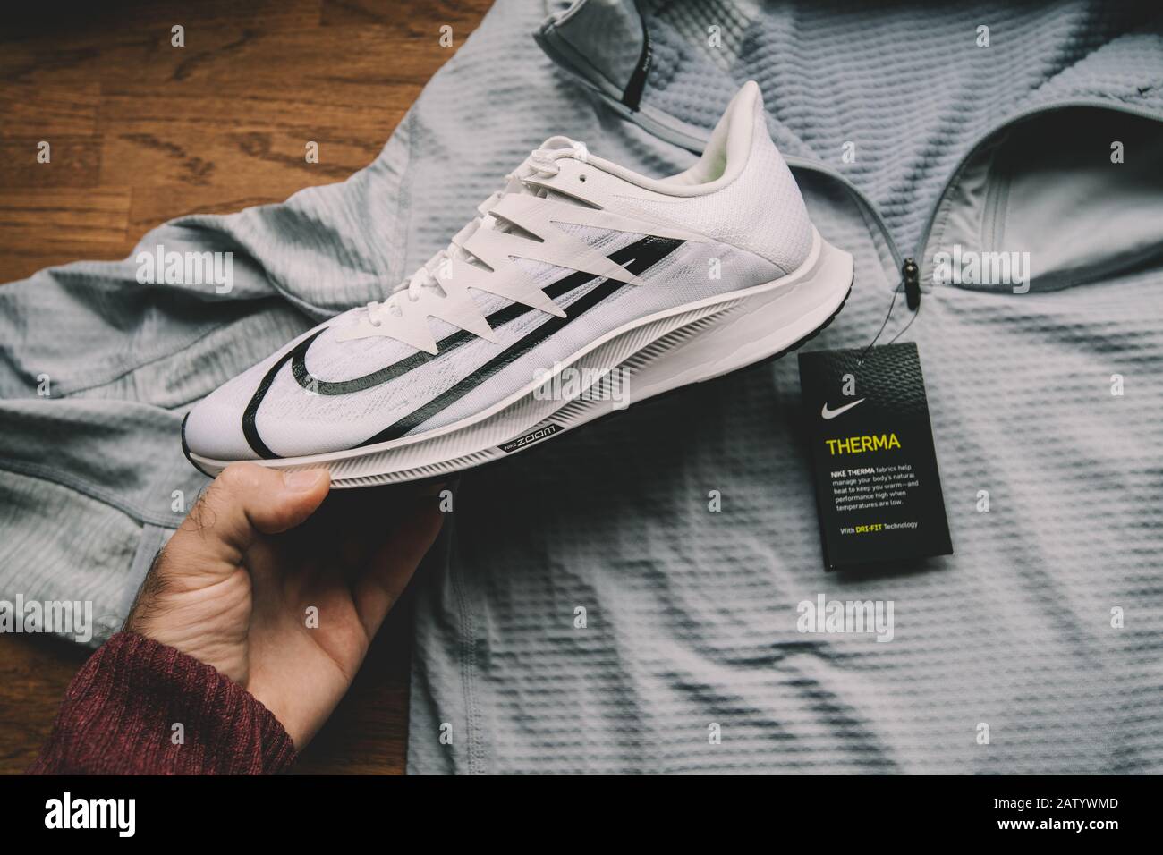 Paris, France - Sep 23, 2019: POV man hand holding Nike Zoom Rival Fly  professional running shoes for women with Nike Derma Dry-Fit clothes in  background Stock Photo - Alamy