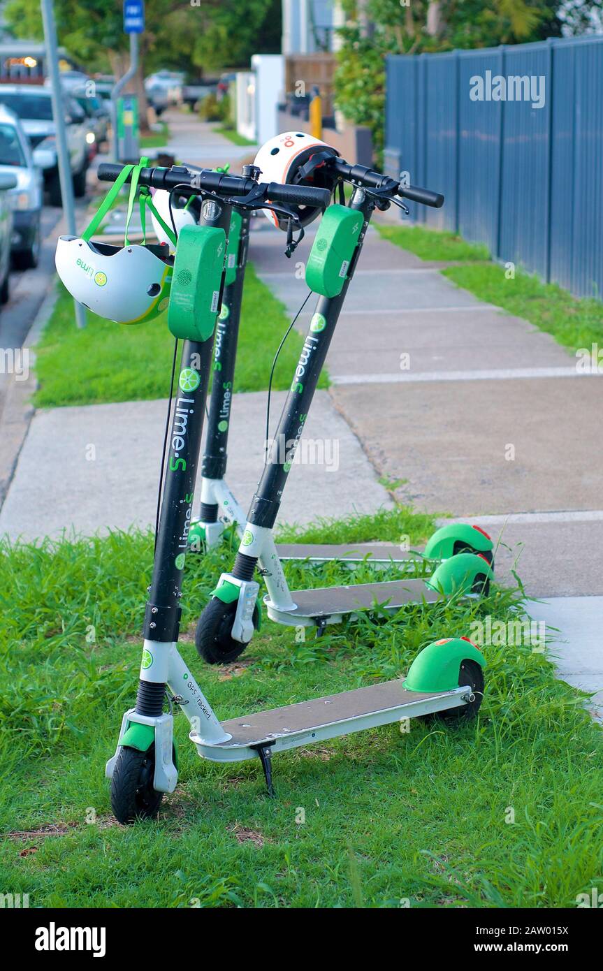 Brisbane, Queensland, Australia - 28th January 2020 : View of some Lime Electric Scooters parked on the sidewalk in Brisbane. This E-scooters used for Stock Photo