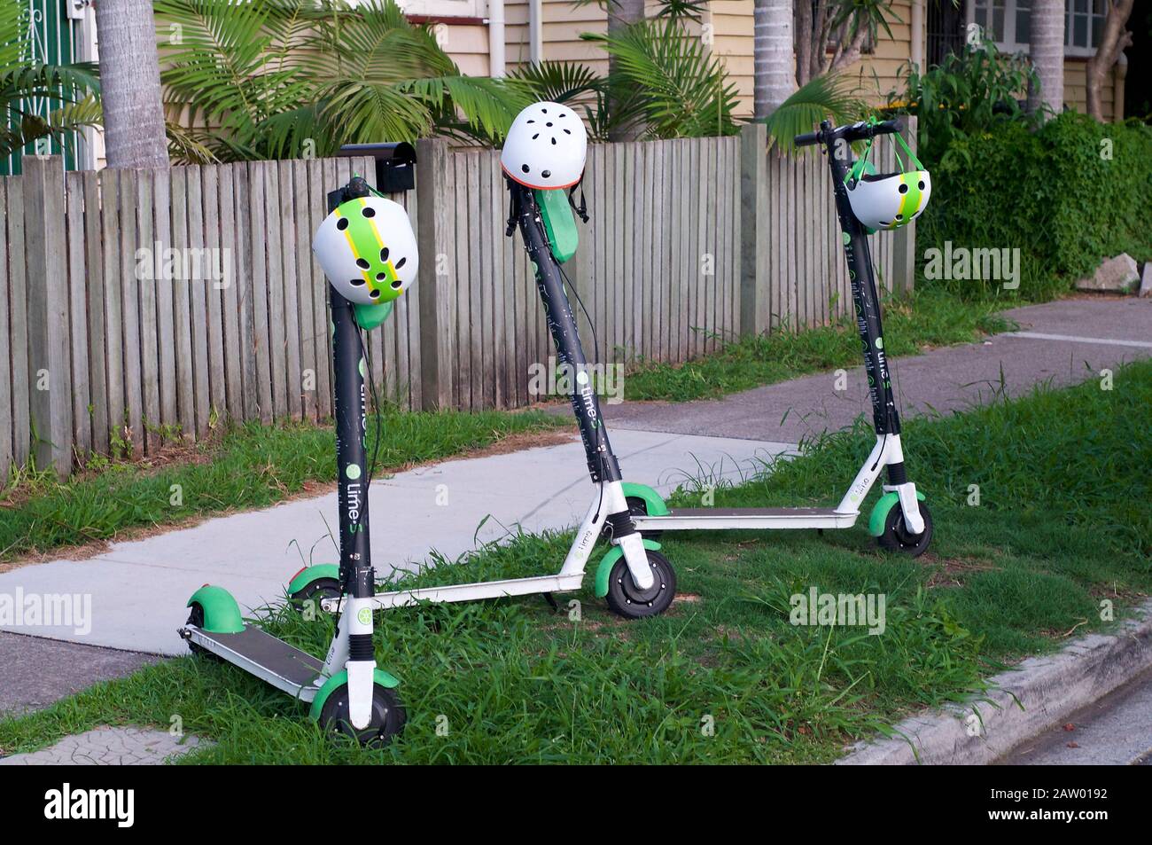 Brisbane, Queensland, Australia - 28th January 2020 : View of some Lime Electric Scooters parked on the sidewalk in Brisbane. This E-scooters used for Stock Photo