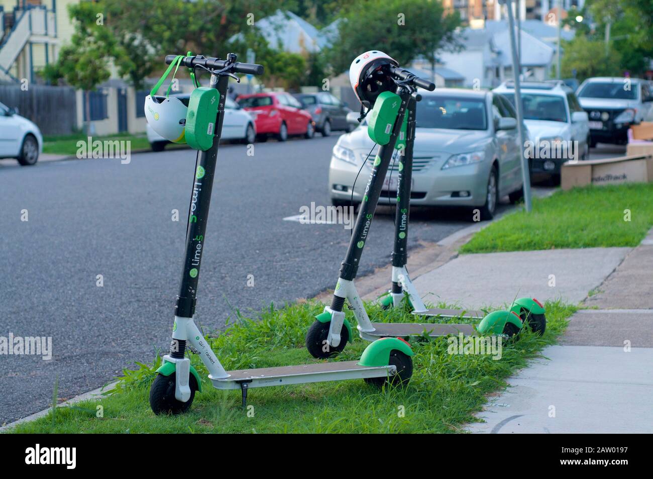 Brisbane, Queensland, Australia - 28th January 2020 : View of some Lime Electric Scooters parked on the sidewalk in Brisbane. This E-scooters used for Stock Photo