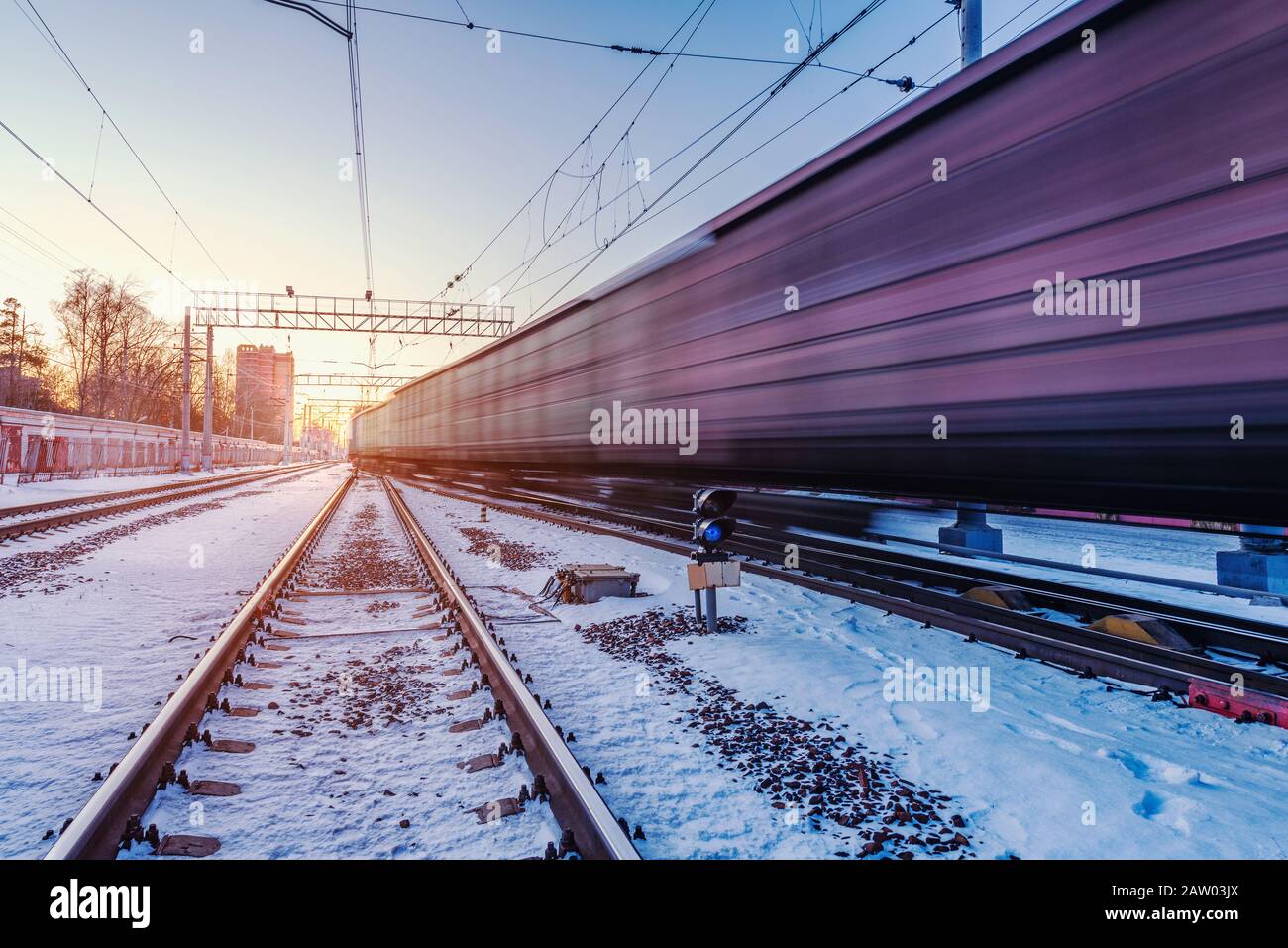 Freight train moves fast through the station. Stock Photo