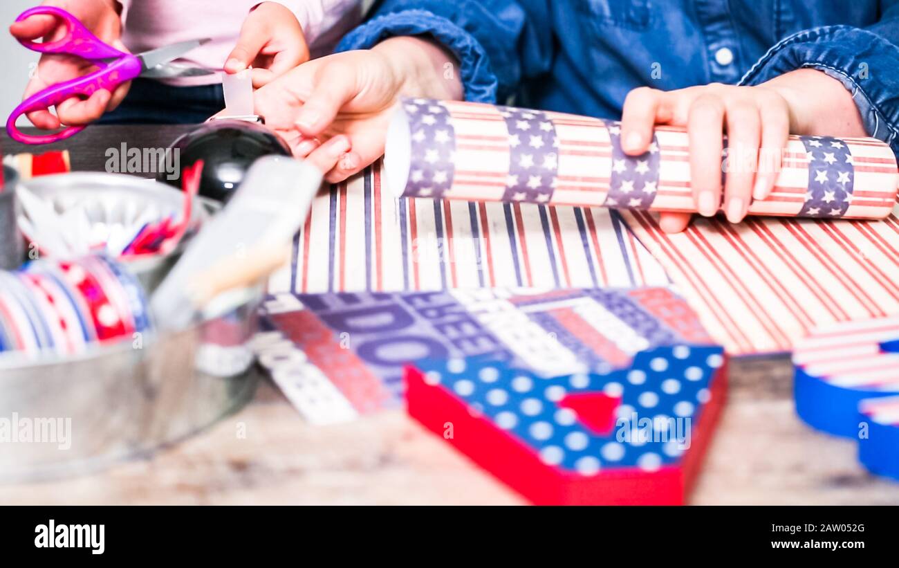 Step by step. Mother and daughter making paper firecrackers for July ...