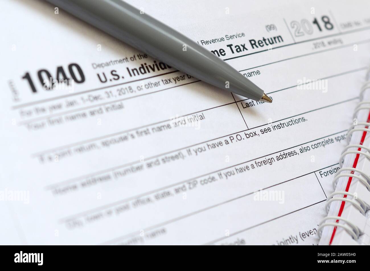 The Pen And Notebook Is Lies On The Tax Form 1040 U S Individual