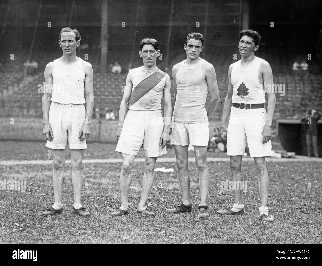 Photograph shows Canadian runners Tom Longboat, Abbie Wood and A. Meadows with American runner Bill Queal. The men participated in a sports exhibition at Ebbets Field, Brooklyn, New York City on July 26, 1913. Stock Photo