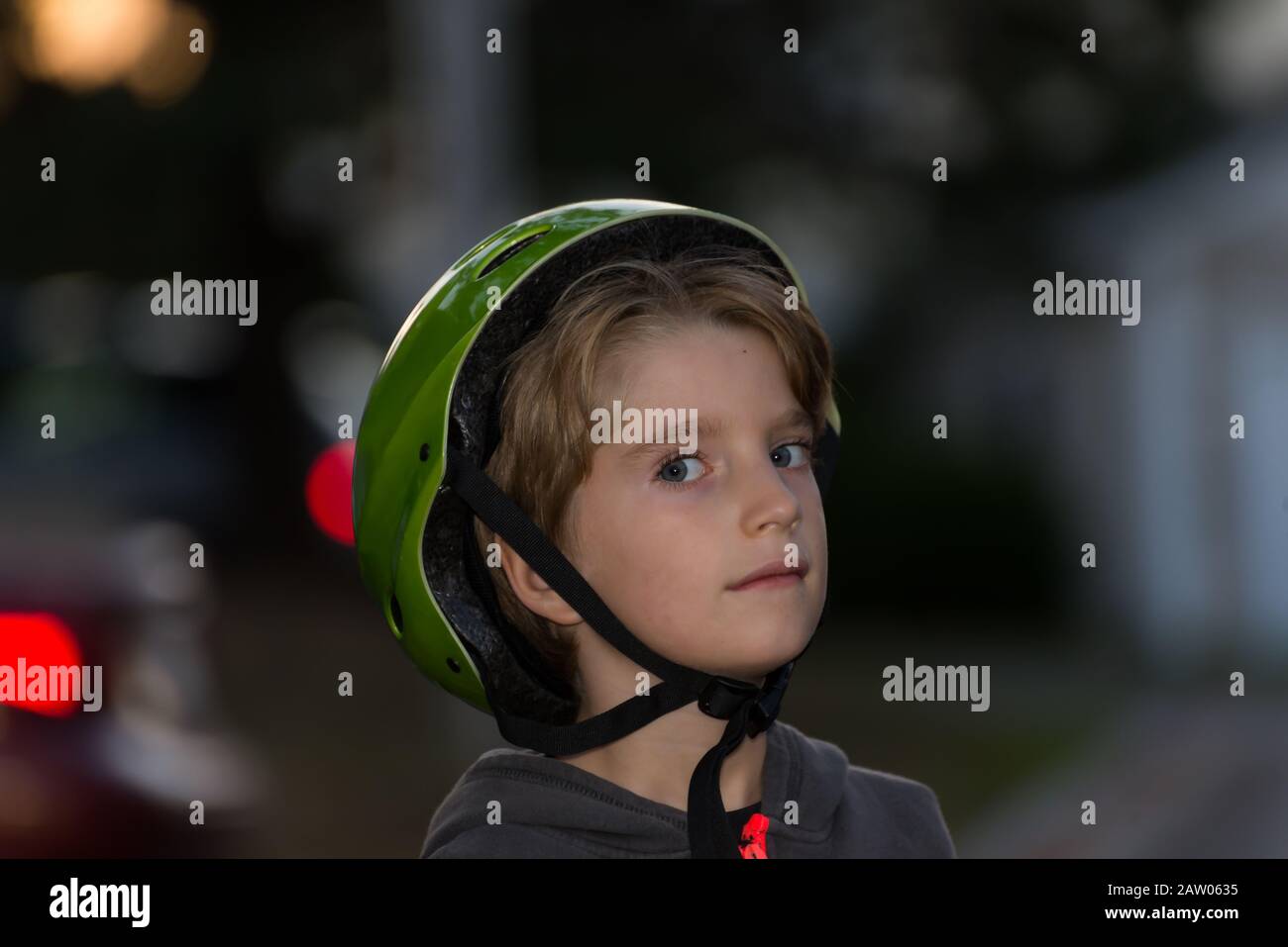 Portrait of a kid wearing a bicycle helmet incorrectly Stock Photo Alamy