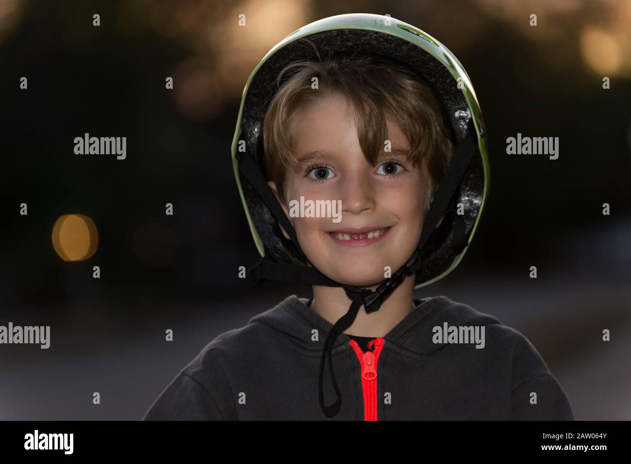 Portrait of a kid wearing a bicycle helmet incorrectly Stock Photo Alamy