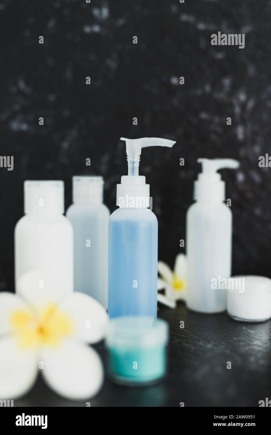 luxury spa concept, lotions and moisturizer bottles on black marble