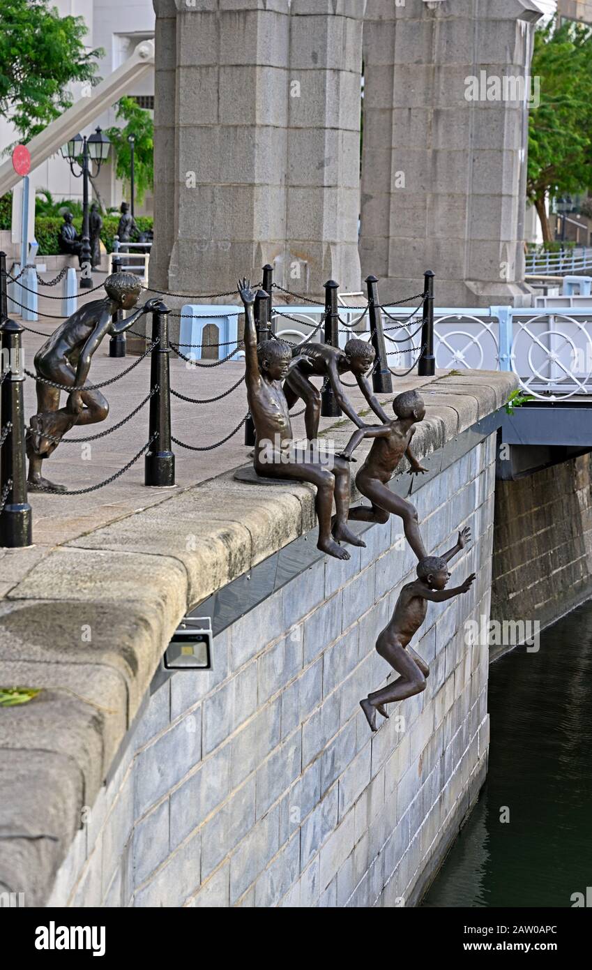 singapore, singapore - 2020.01.24: bronze sculpture at the singapore river near cavenagh bridge by chong fah cheong titled the first generation Stock Photo