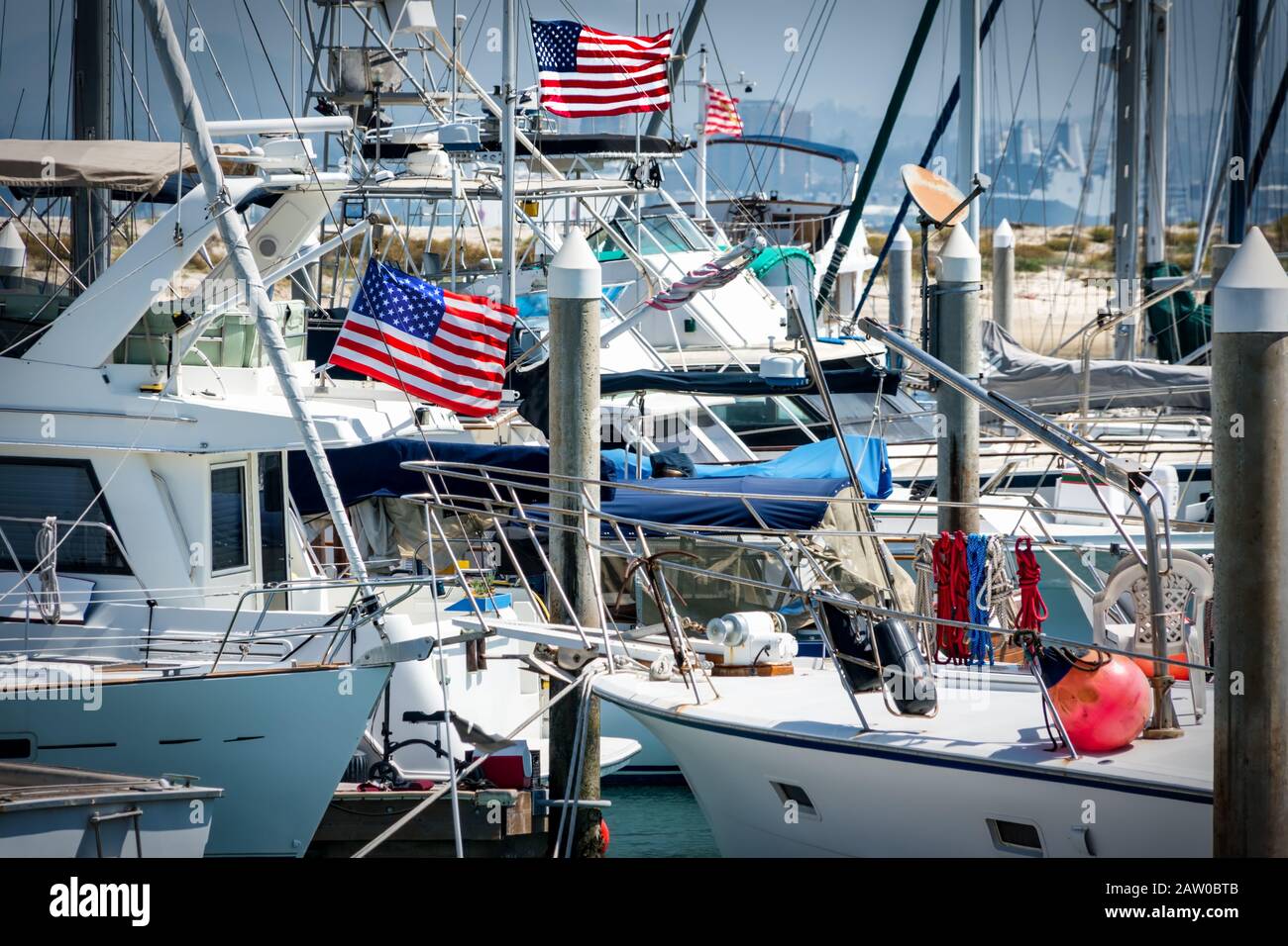 American flags flying on boats in a southern California marina Stock