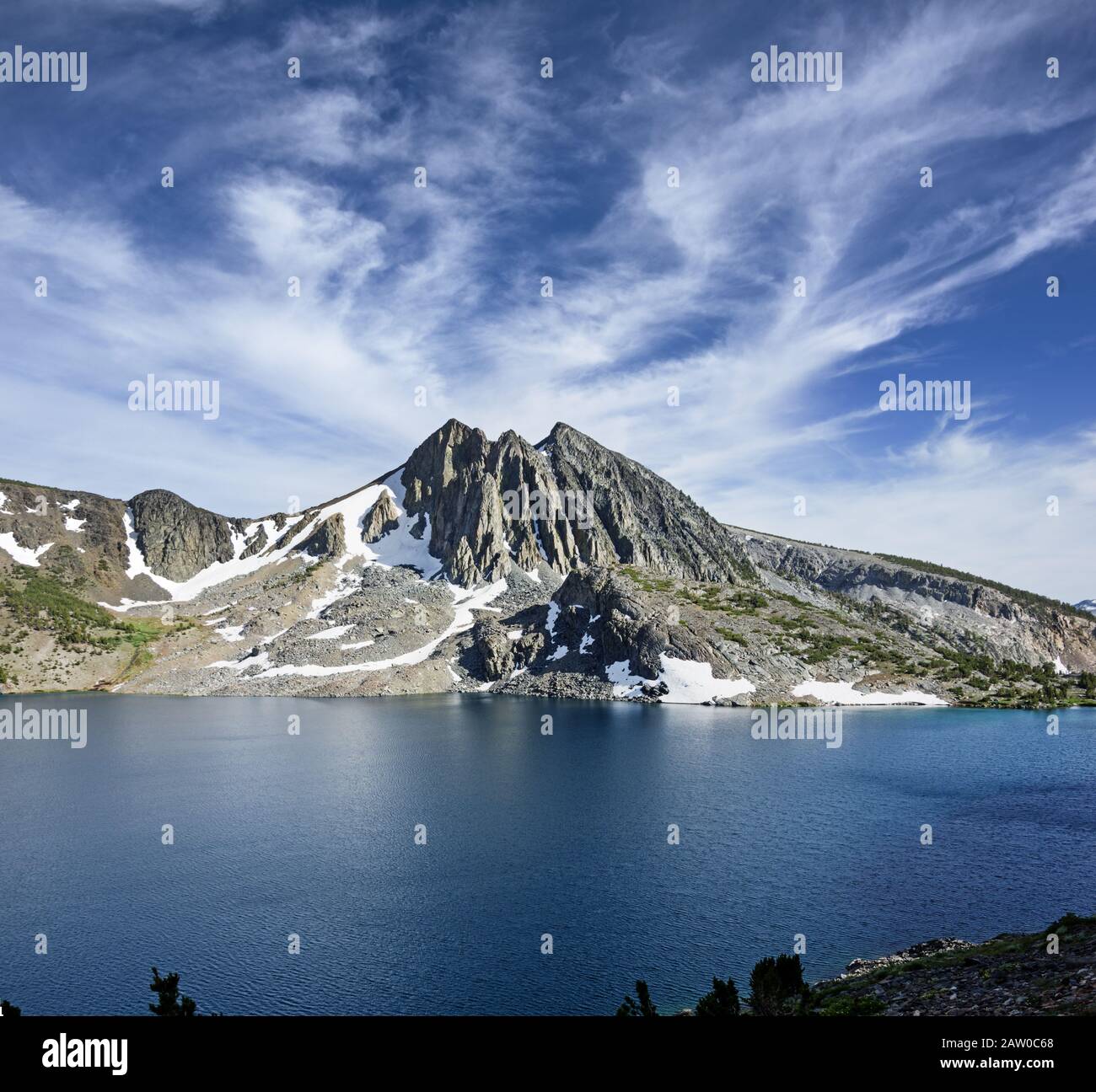 mountain rising above Duck Lake with interesting clouds in the John Muir Wilderness Stock Photo