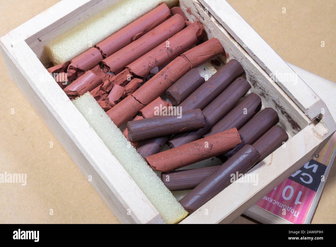 Russian sanguine and sepia and red drawing sticks in a wooden box Stock Photo