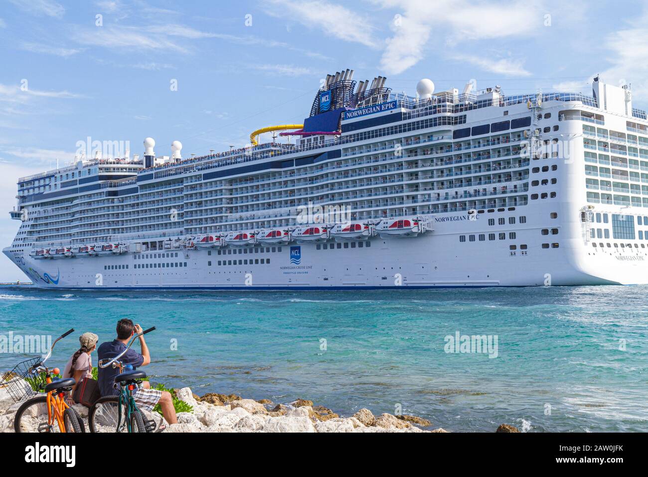 Miami Beach Florida,South Pointe Park,Point,Government Cut,Port of Miami,departing cruise ship,Norwegian Epic,NCL,couple watching,bicycles,visitors tr Stock Photo