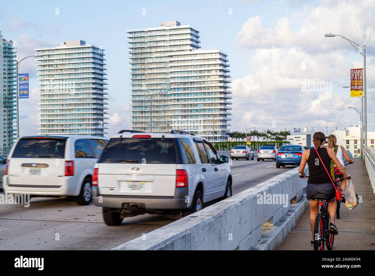 Miami Beach Florida,MacArthur Causeway,traffic,vehicles,adult adults woman women female lady,biker bikers bicycle bicycles,bicycling biking riding rid Stock Photo