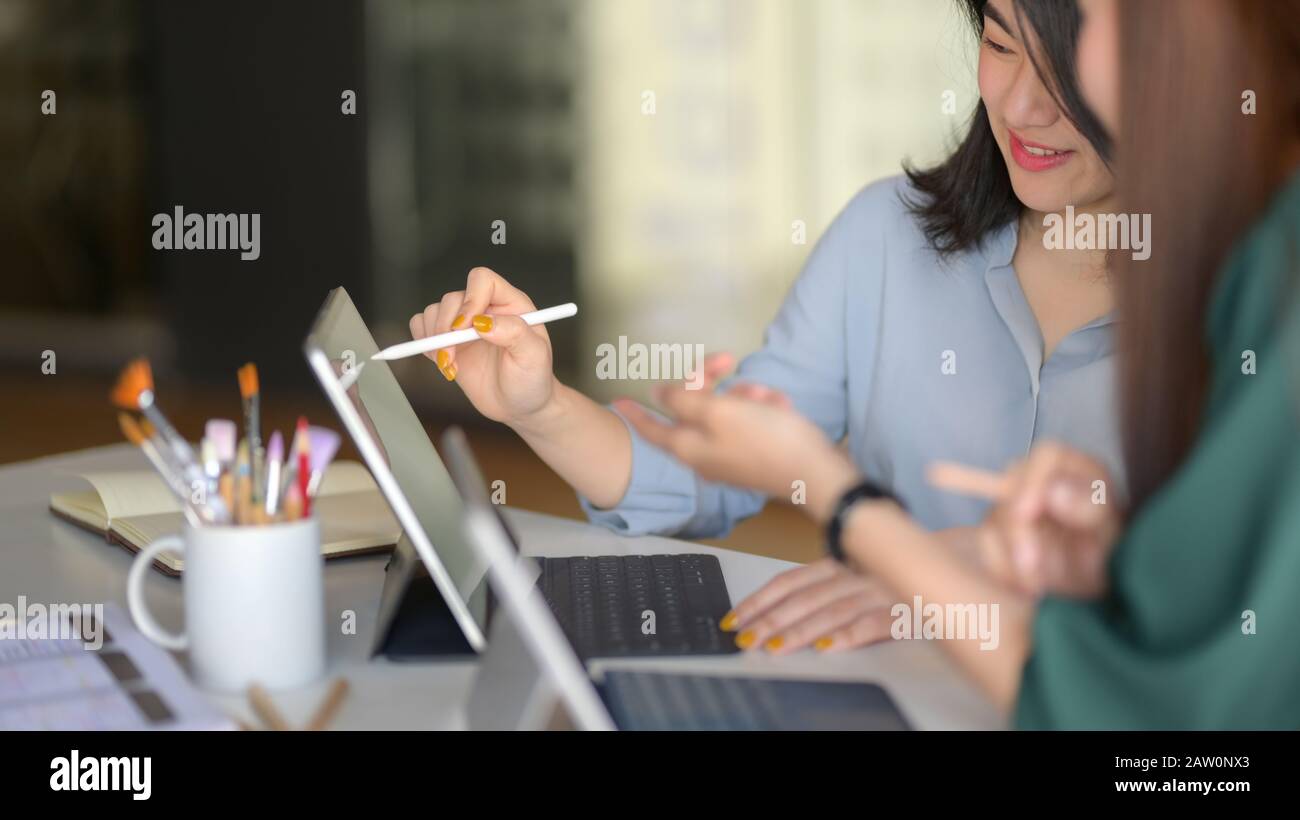 Cropped shot of professional designer team consulting on their project in modern meeting room Stock Photo