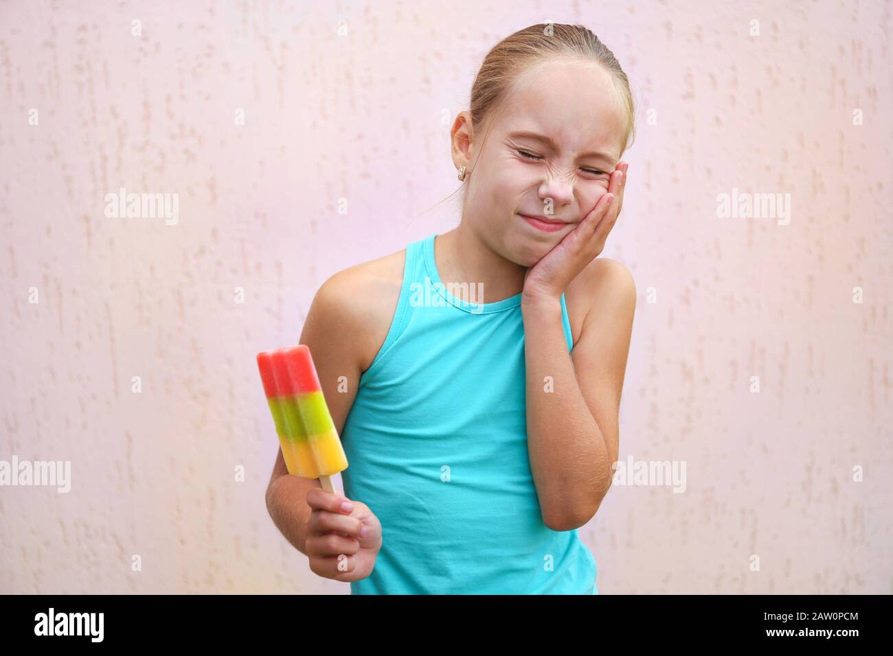 Girl has toothache from cold ice cream Stock Photo Alamy