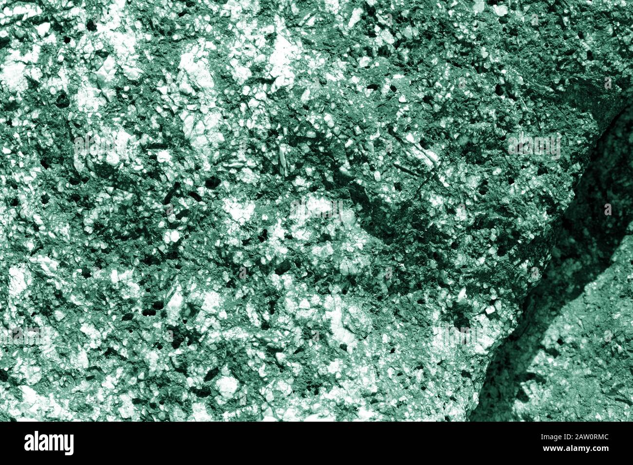 Seashore rocks texture close-up. Natural stone background green color toned Stock Photo