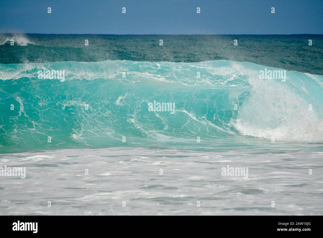 Surfers riding world-renowned crashing waves in Banzai Pipeline on North Shore, Oahu island, Haleiwa, Hawaii, USA Stock Photo