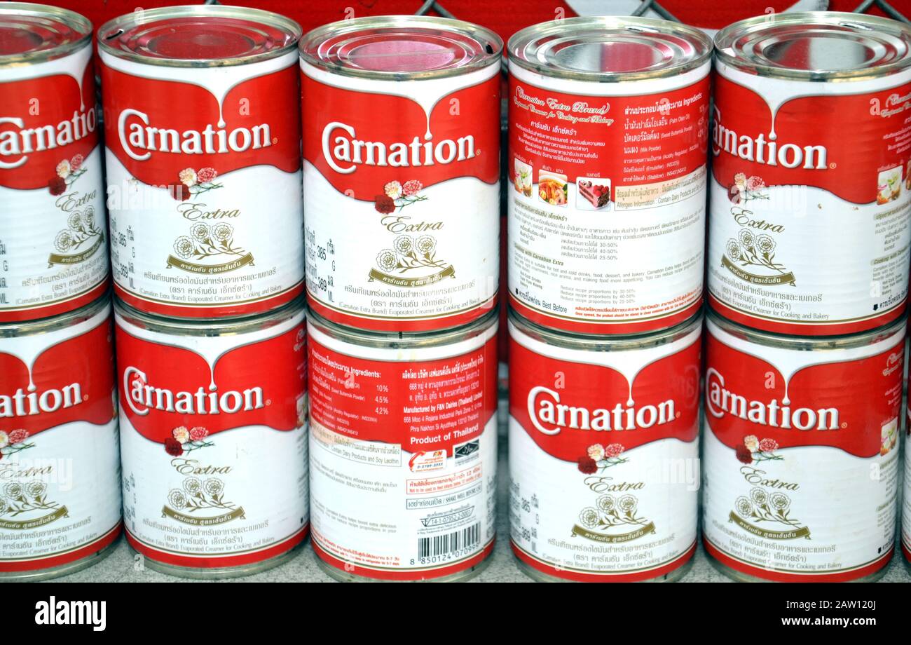 A double row of tins of Carnation Milk in Bangkok, Thailand, Asia Stock Photo