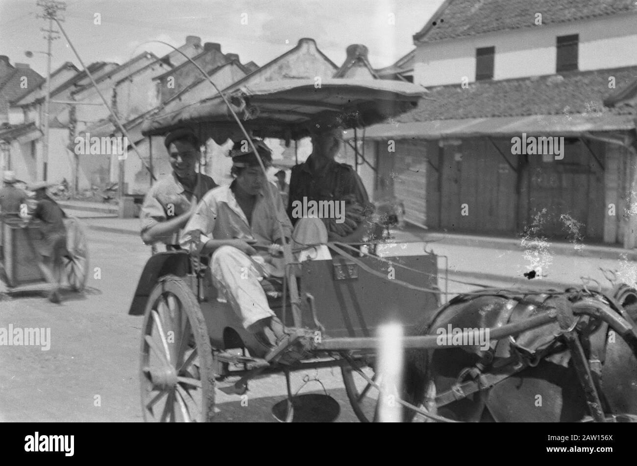 Salatiga providing clothing and passarbeeld  Also in Salatiga, life returned to normal jobs and will be purchased on the pasars and acted. The soldiers are of course the best customers. In dokar Annotation: In the background ruined buildings Date: August 31, 1947 Location: Indonesia Dutch East Indies Stock Photo