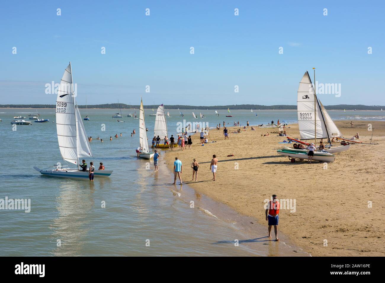 Vacationers launch a catamaran. St-Trojan beach, Ile d'Oleron France. Stock Photo