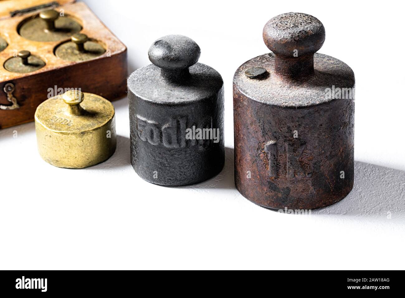 Old rustic metal weights on white background Stock Photo Alamy