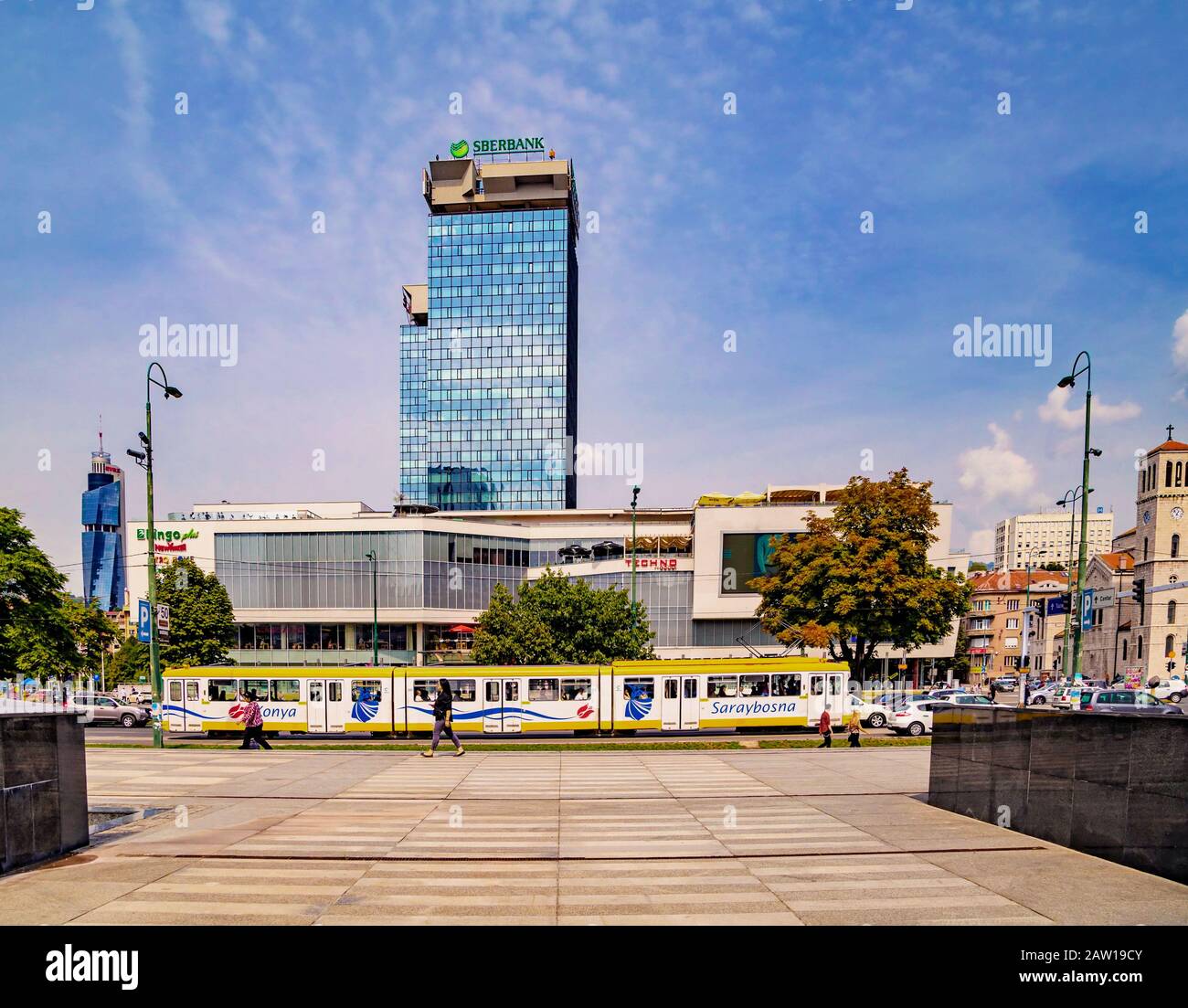 Street view of Novo Sarajevo with UNITIC Business Center ( Unis towers) and the yellow tram.At the background the Avaz Twist Tower . Stock Photo