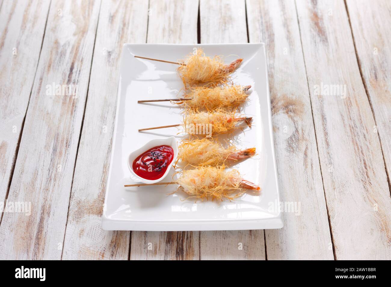 Crispy Shrimp wrapped in dough Kataifi called also Kanafeh, Kadaif. Served  with sauce on old wooden white background Stock Photo - Alamy