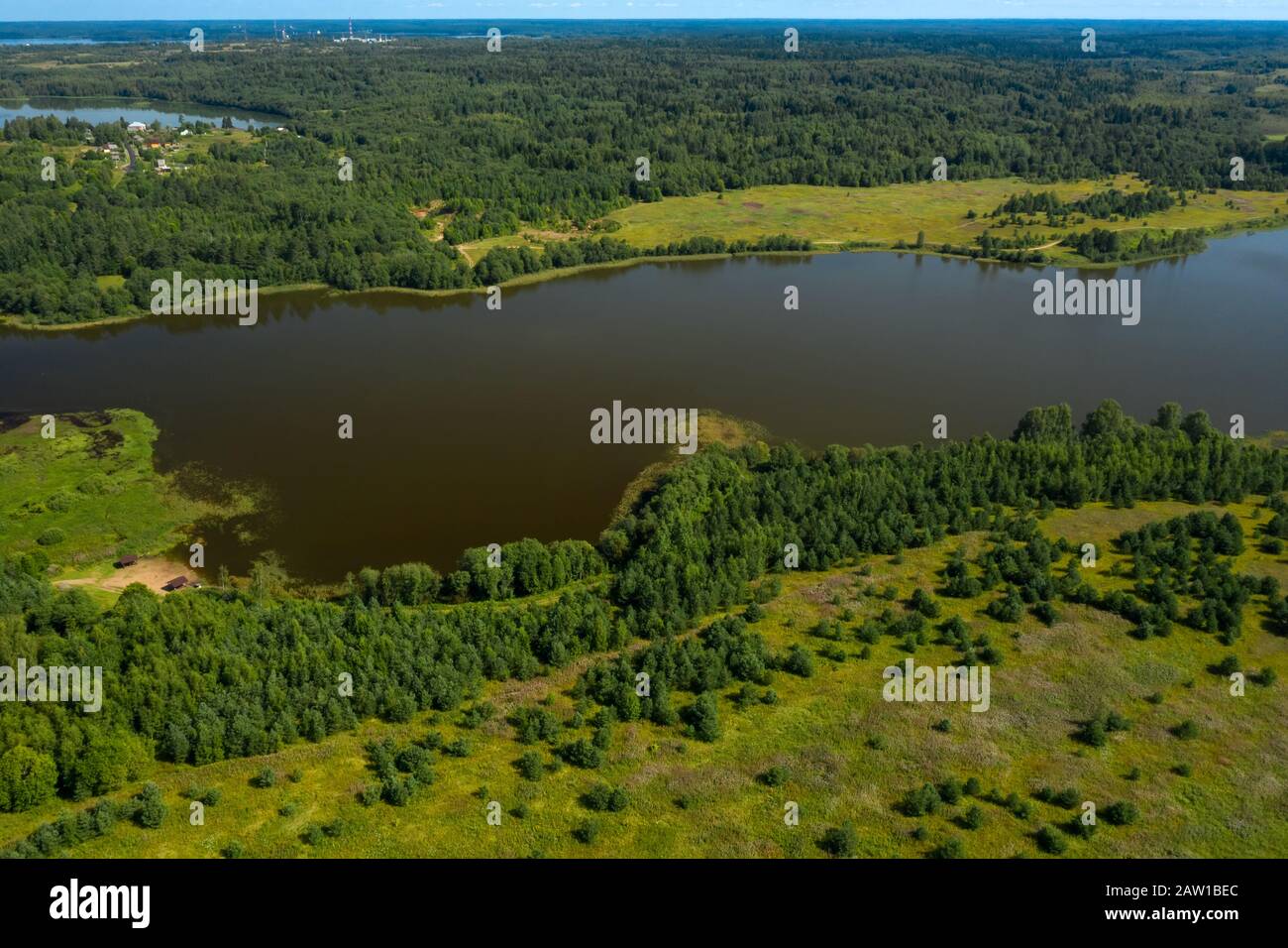 Aerial view from above on a forest lake and and its surroundings Stock