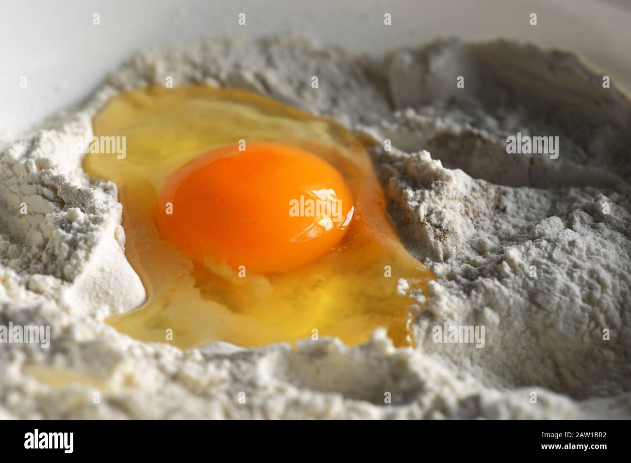 Bio Egg Yolk In Heap Of Flour Stock Photo