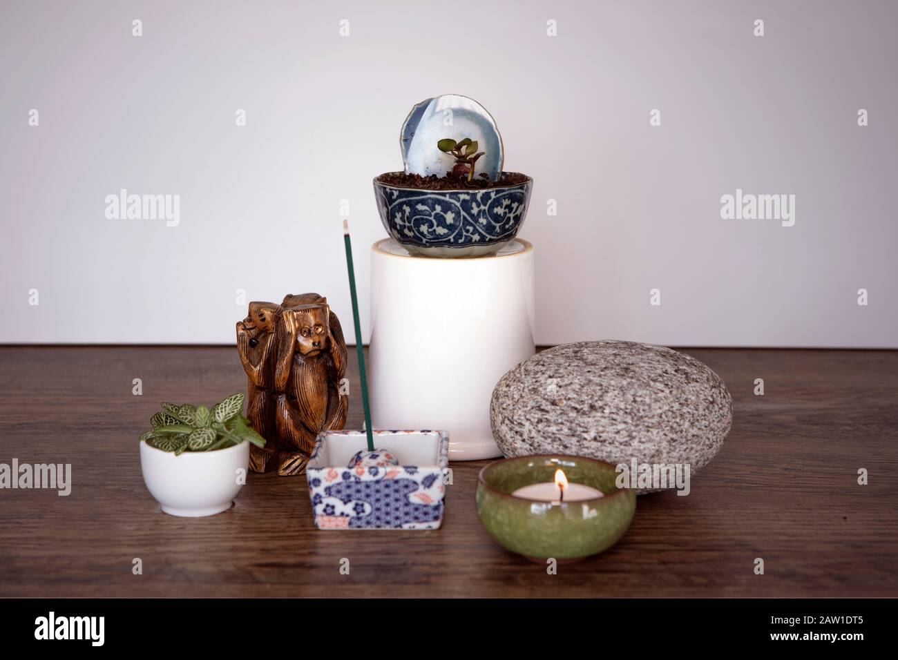 Home altar. Spiritual decor arrangement with burning candle, incense  sticks, stone and fresh plants. Spirituality at home concept. Mini Zen  Japanese s Stock Photo - Alamy