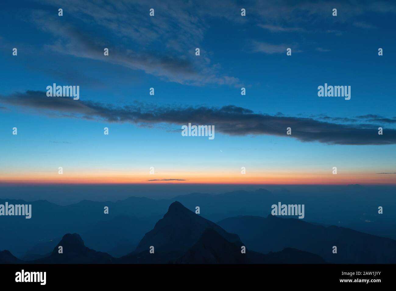 Beautiful twilight sky before sunrise in Alpine mountain ranges in Slovenia, Triglav National Park. Travel, environment and self-reflection concepts Stock Photo