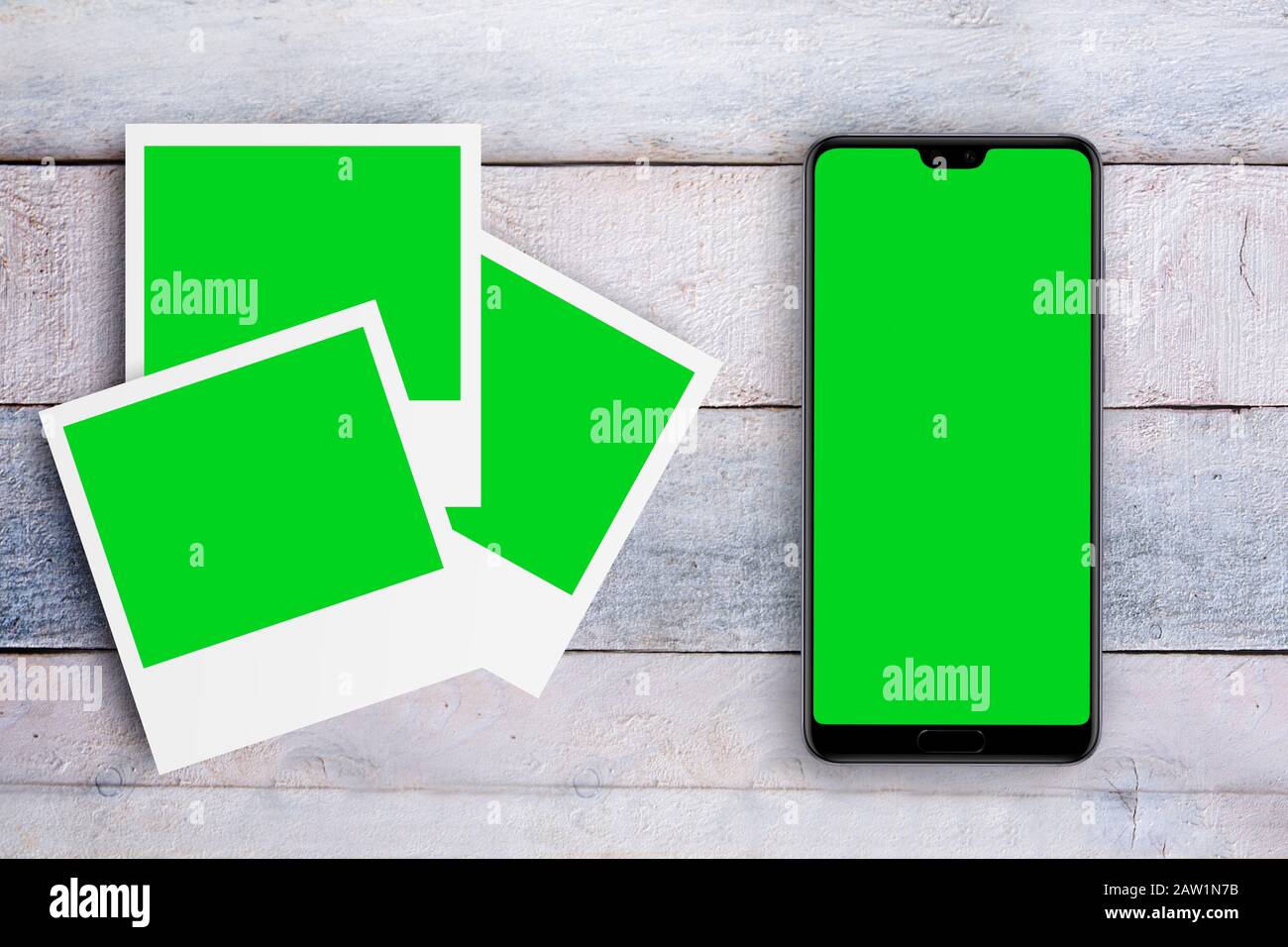 Mobile with green screen next to some photo frames on a white wooden  desktop. Chroma key for mock up project and empty copy space for Editor's  content Stock Photo - Alamy