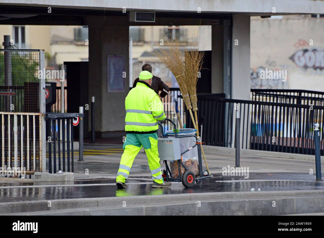 A road cleaner using traditional birch besom brooms for street sweeping in Montpellier, France Stock Photo