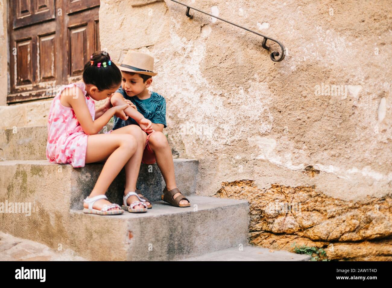 Girl healing a boy a wound in a summer day Stock Photo - Alamy