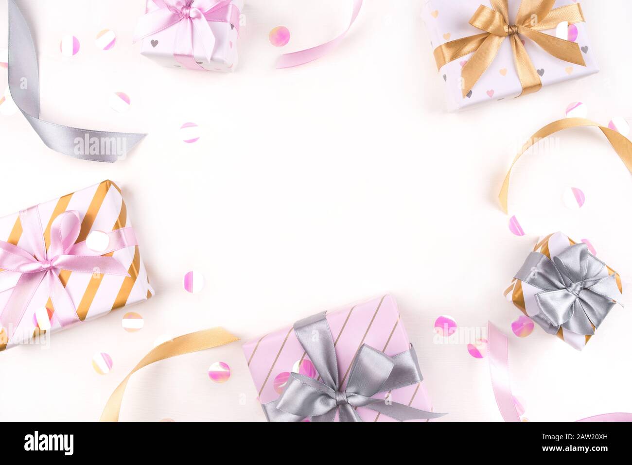 Several gift boxes with bows and confetti on a white background. Stock Photo