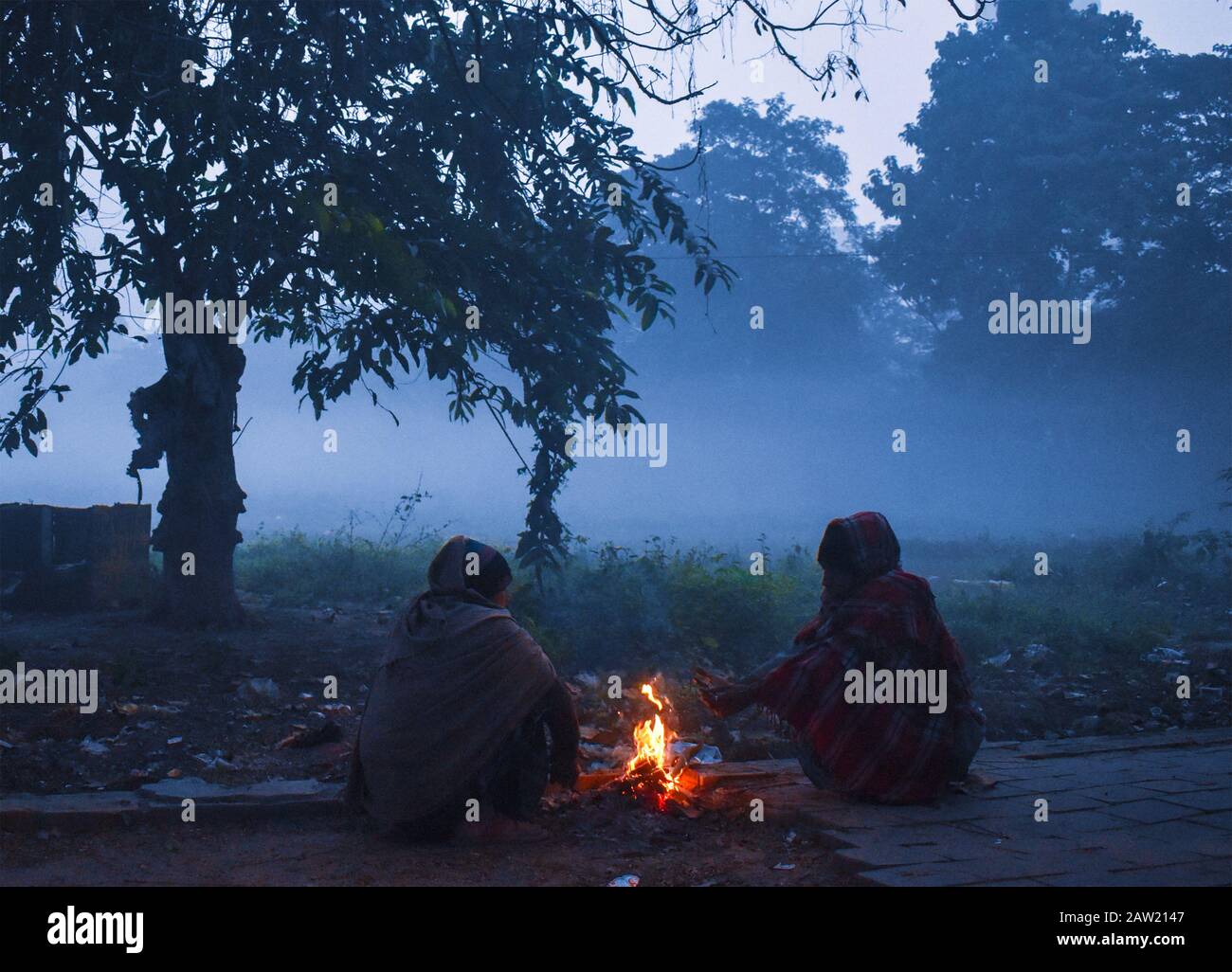 Peoples are warm himself by fire on the winter cold morning in Kolkata, India. Stock Photo